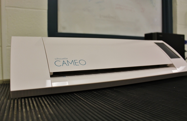 The Silhouette Cameo (pictured above) is a paper cutter that can cut intricate designs as pictured in the image at the top of this page.